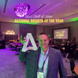DC Copeland holding the 2025 National Broker of the Year award at the Hall of AIME ceremony